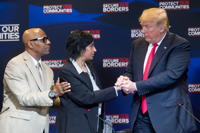 Donald Trump shakes and then holds onto Evelyn Rodriguez’s hand.